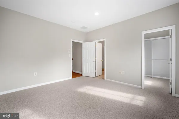 a bedroom with a bed and couch