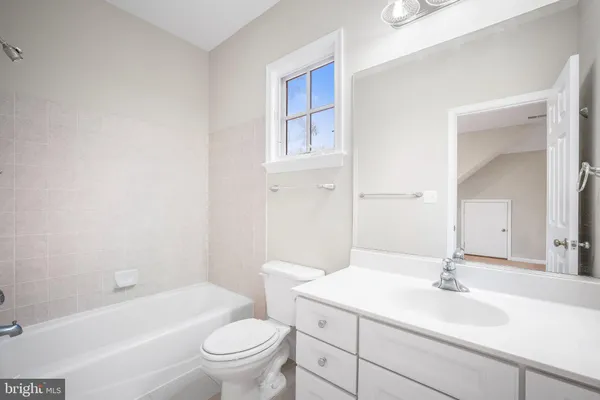 a spacious bathroom with a tub sink shower and mirror