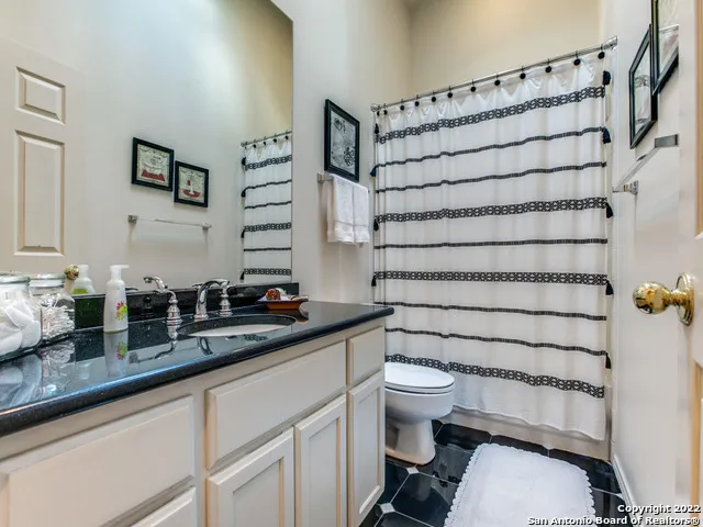 a bathroom with a sink a toilet and a mirror