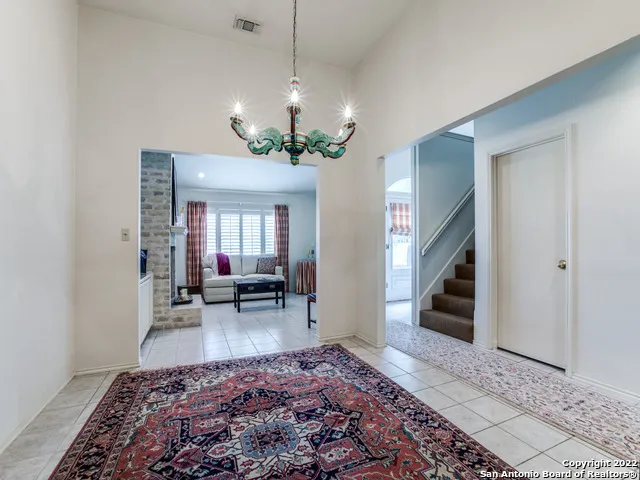 a living room with furniture rug and a fireplace