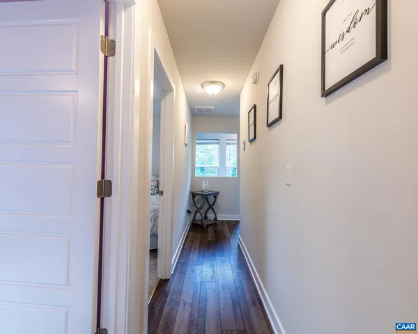 a view of a hallway view with wooden floor and staircase