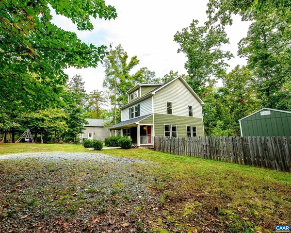 a view of a house with a yard and sitting area