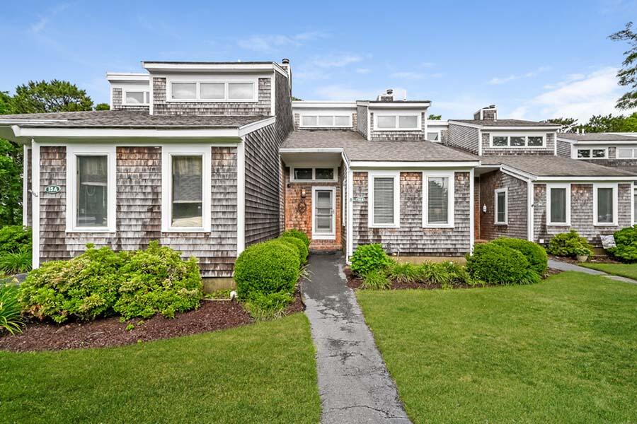 front view of a brick house with a yard