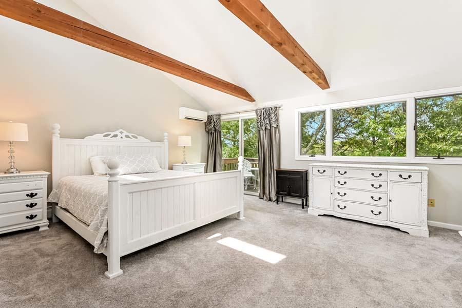 15 Riverview Avenue, Unit B Mashpee, MA 02649 - Photo 13 of 28 a large white bed sitting in a room next to a window