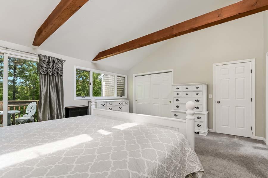 15 Riverview Avenue, Unit B Mashpee, MA 02649 - Photo 14 of 28 a large bed sitting in a bedroom next to a window