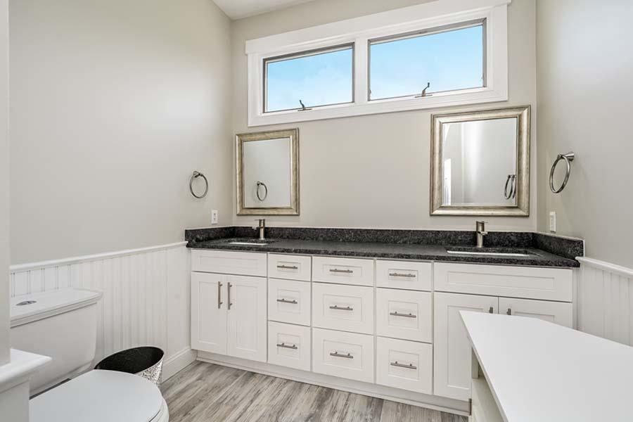 15 Riverview Avenue, Unit B Mashpee, MA 02649 - Photo 17 of 28 a bathroom with a granite countertop toilet sink and mirror