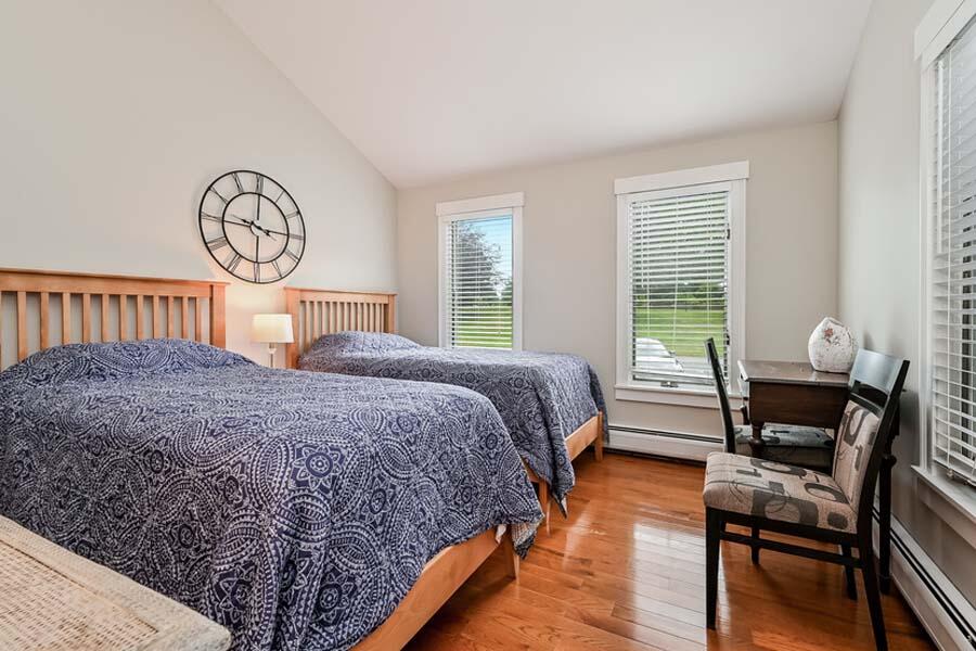 15 Riverview Avenue, Unit B Mashpee, MA 02649 - Photo 18 of 28 a bedroom with a bed a dresser and windows