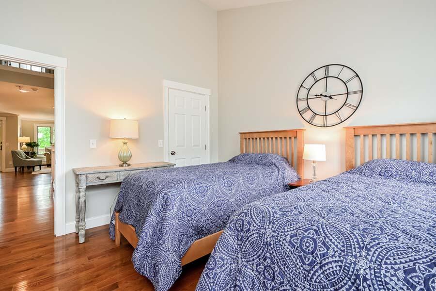 15 Riverview Avenue, Unit B Mashpee, MA 02649 - Photo 19 of 28 a bedroom with bed and a chandelier