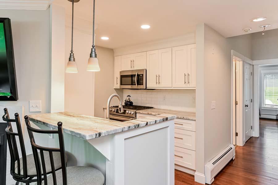 15 Riverview Avenue, Unit B Mashpee, MA 02649 - Photo 4 of 28 a kitchen with a stove a sink and a refrigerator