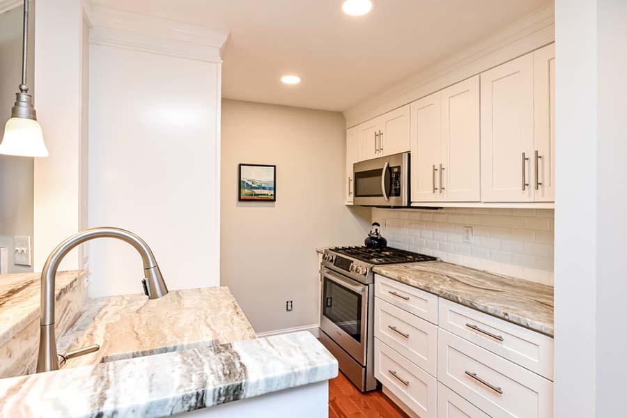15 Riverview Avenue, Unit B Mashpee, MA 02649 - Photo 5 of 28 a kitchen with a stove a sink and a microwave
