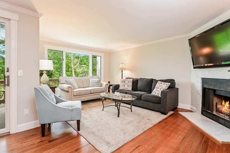 15 Riverview Avenue, Unit B Mashpee, MA 02649 - Photo 8 of 28 a living room with furniture a flat screen tv and a fireplace