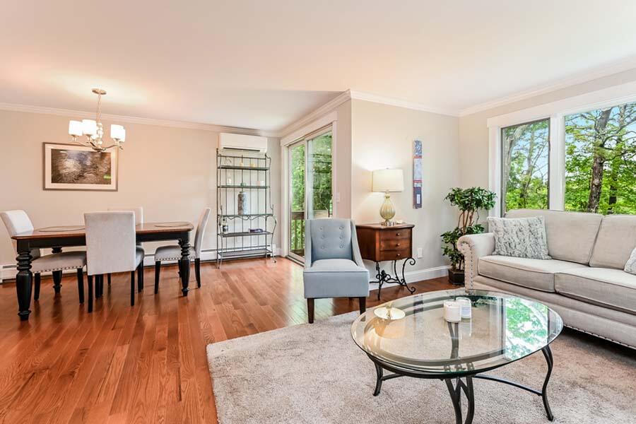 15 Riverview Avenue, Unit B Mashpee, MA 02649 - Photo 9 of 28 a living room with furniture a dining table and a potted plant