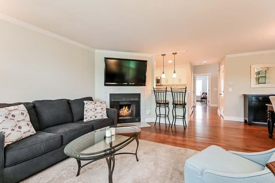 15 Riverview Avenue, Unit B Mashpee, MA 02649 - Photo 10 of 28 a living room with furniture a flat screen tv and a fireplace