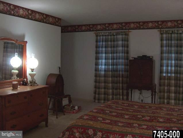 2760 Stoverstown Road, Unit 5 Spring Grove, PA 17362 - Photo 6 of 9 a bedroom with a bed and a mirror