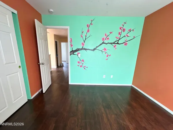 a view of an entryway with wooden floor