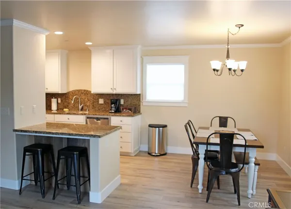 a view of a dining room with furniture and chandelier