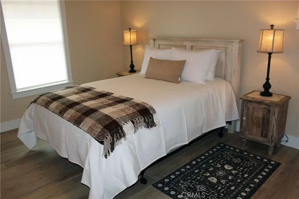 a bedroom with double bed and a window