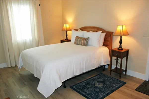 a bed sitting in a bedroom with a lamp