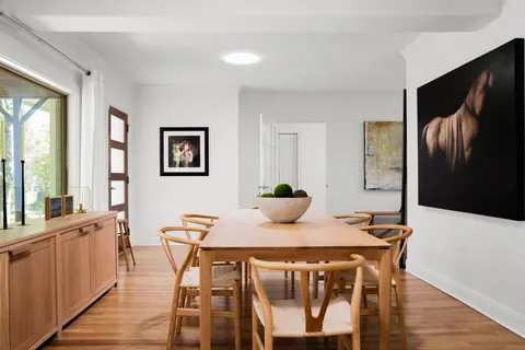 a view of a dining room with furniture and wooden floor