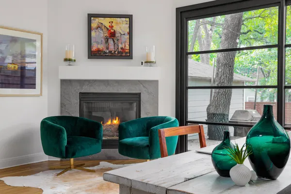 a living room with furniture a potted plant and a fireplace