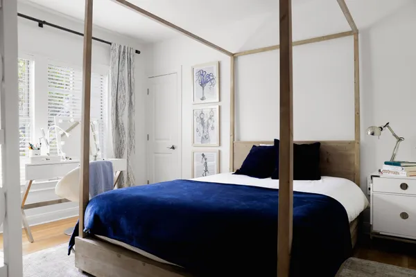 a bedroom with a bed and a window