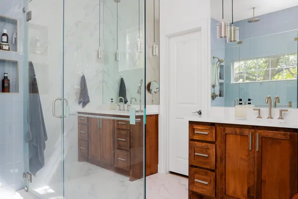 a bathroom with a sink a mirror and a shower