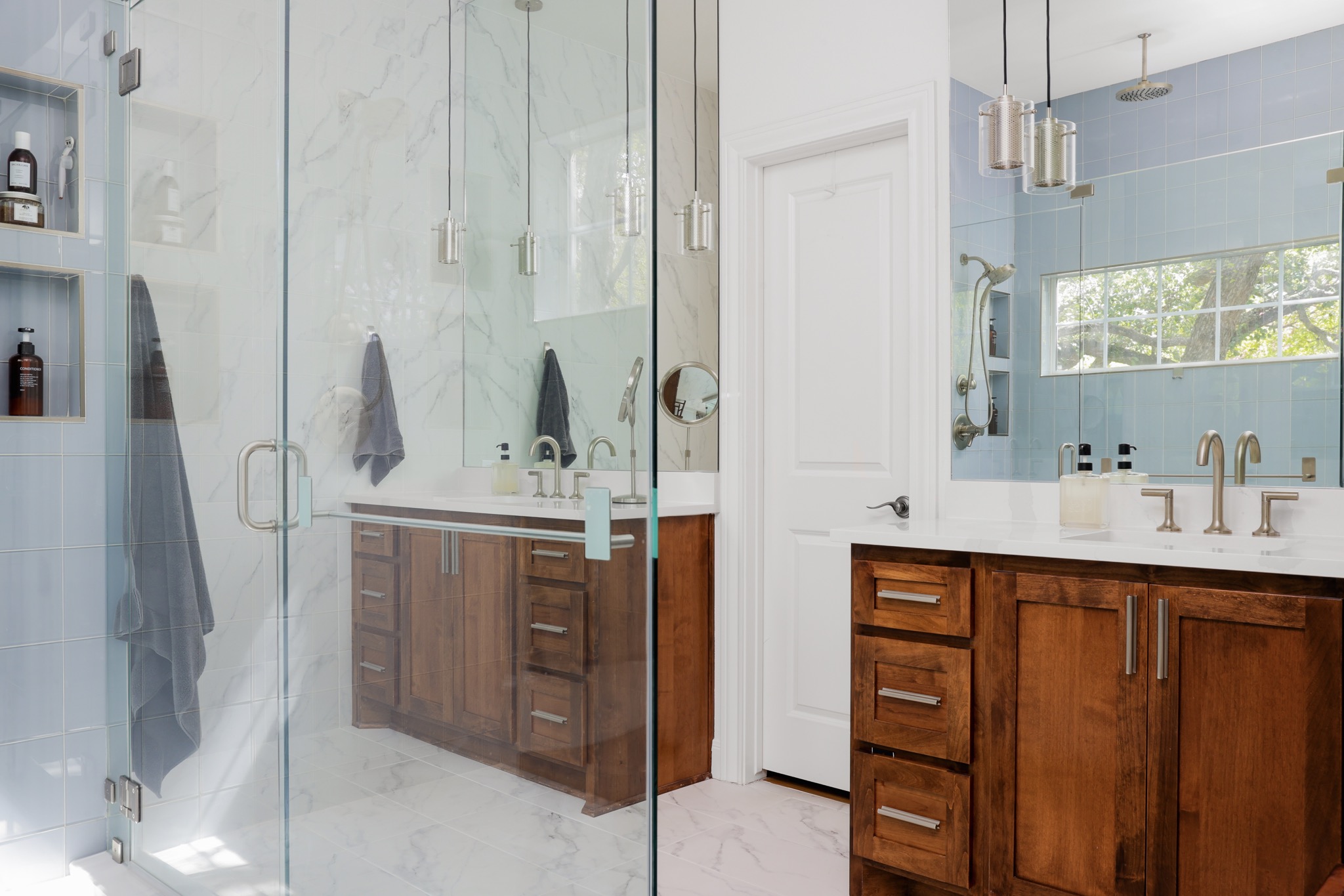 2803 Bridle Path Austin, TX 78703 - Photo 19 of 21 Bathroom featuring a marble finish shower, two vanities, light marble finish flooring, and tile walls