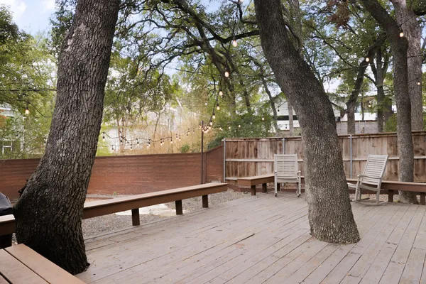 a wooden bench sitting in the middle of a yard