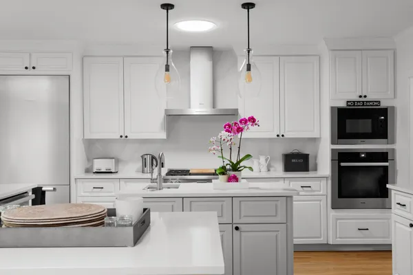 a kitchen with kitchen island granite countertop a sink cabinets and stainless steel appliances