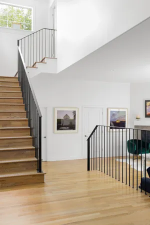 a view of entryway and hall with wooden floor
