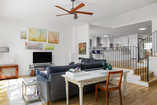 a living room with furniture a flat screen tv and a table