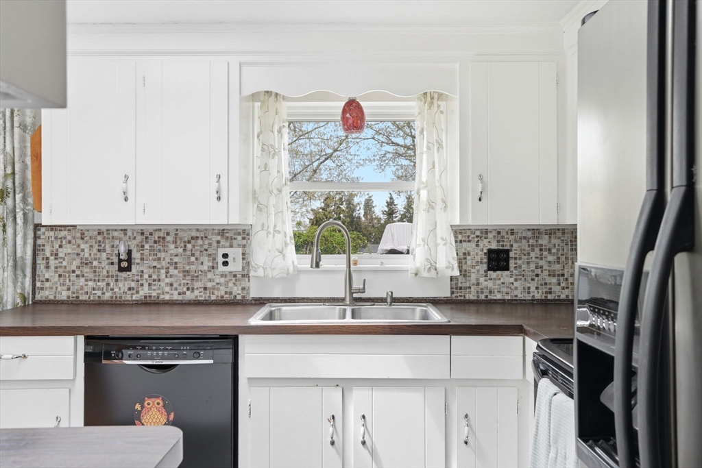 94 Edgewater Drive Wareham, MA 02571 - Photo 19 of 37 a kitchen with a sink and a refrigerator