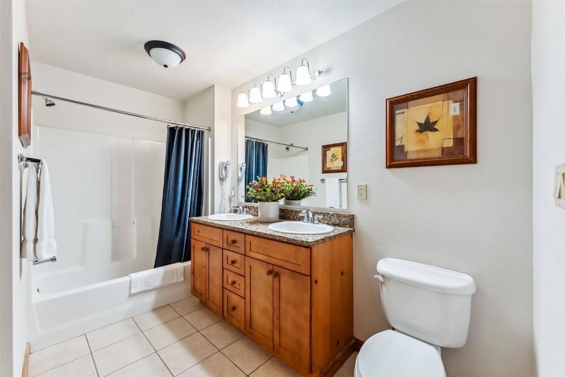 17 Lake Ridge Circle, Unit 1826 Keystone, CO 80435 - Photo 11 of 28 Bathroom featuring tile patterned floors, shower / bathtub combination with curtain, a sink, and toilet