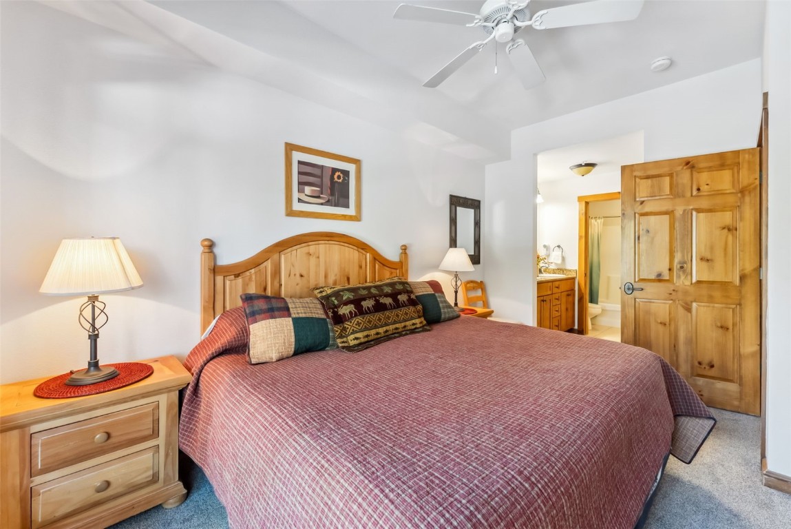 17 Lake Ridge Circle, Unit 1826 Keystone, CO 80435 - Photo 17 of 28 Bedroom featuring light colored carpet, ensuite bath, and a ceiling fan