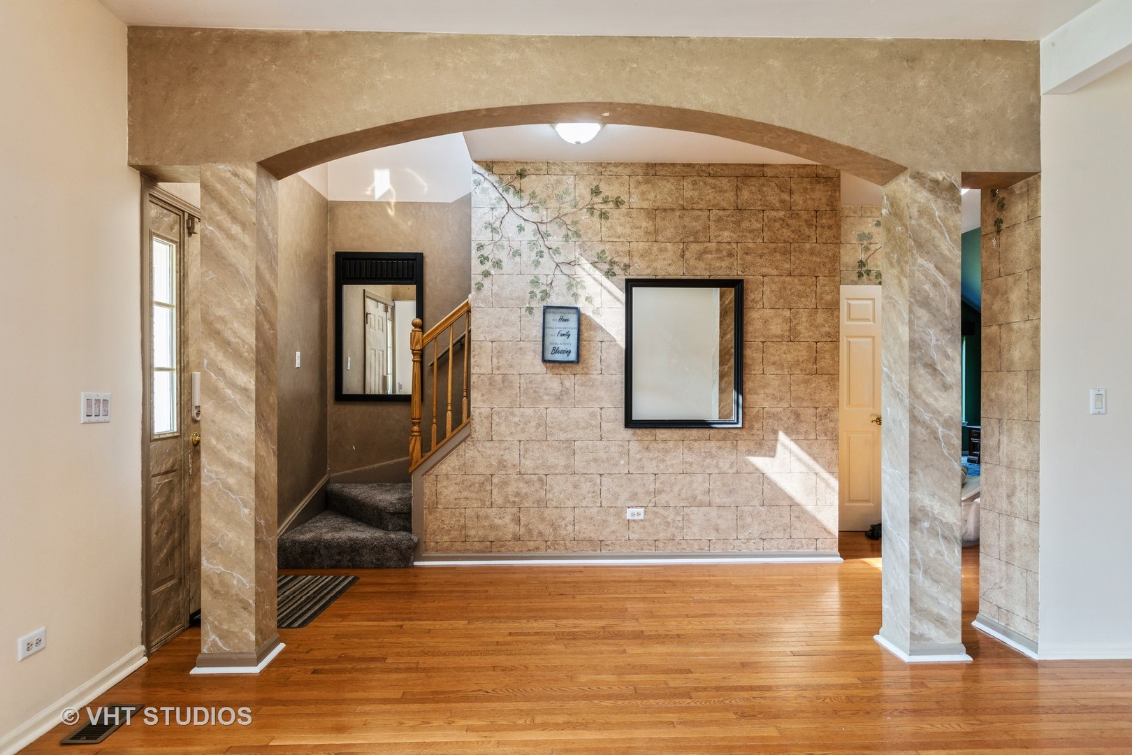 28494 Wagon Trail Road Lakemoor, IL 60051 - Photo 7 of 17 a view of a hallway with wooden floor and a living room