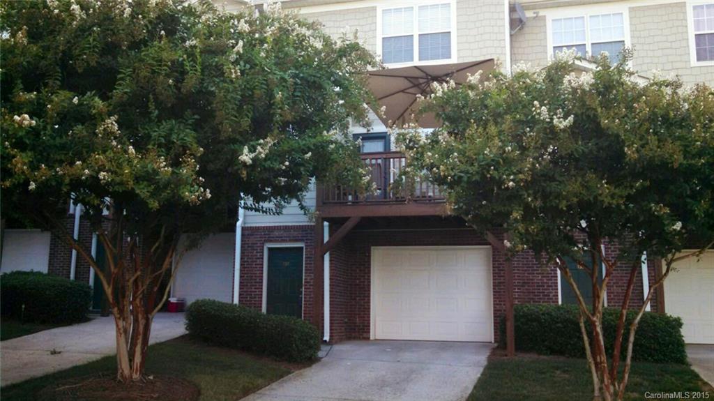 137 High Ridge Road, Unit 64 Mooresville, NC 28117 - Photo 1 of 5 a front view of a house with a yard and garage