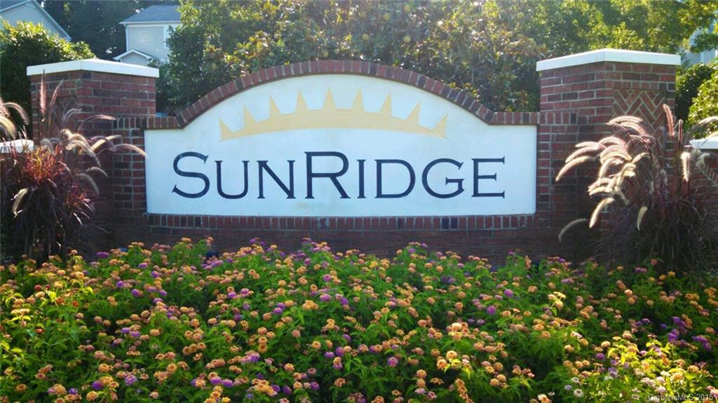 137 High Ridge Road, Unit 64 Mooresville, NC 28117 - Photo 3 of 5 a sign that is sitting in front of flowers