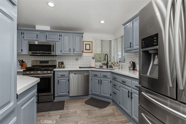 a kitchen with a sink stove and microwave