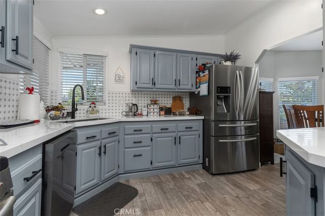 a kitchen with stainless steel appliances a refrigerator sink and cabinets