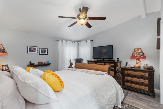 a bedroom with a bed and flat screen tv