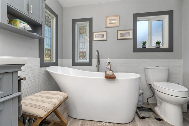 a living room with a toilet a sink and a mirror