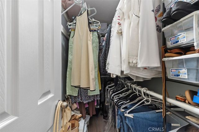 a view of walk in closet with clothes