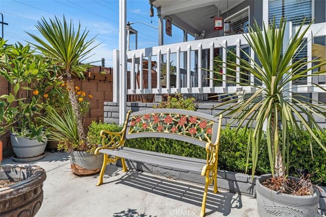 a garden with flowers and outdoor seating