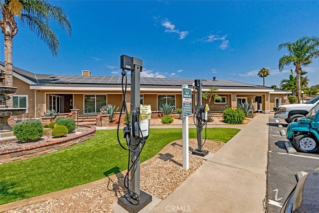 a view of a house with backyard porch and sitting area