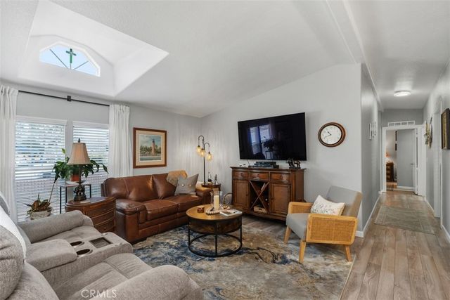 a living room with furniture flat screen tv and a window