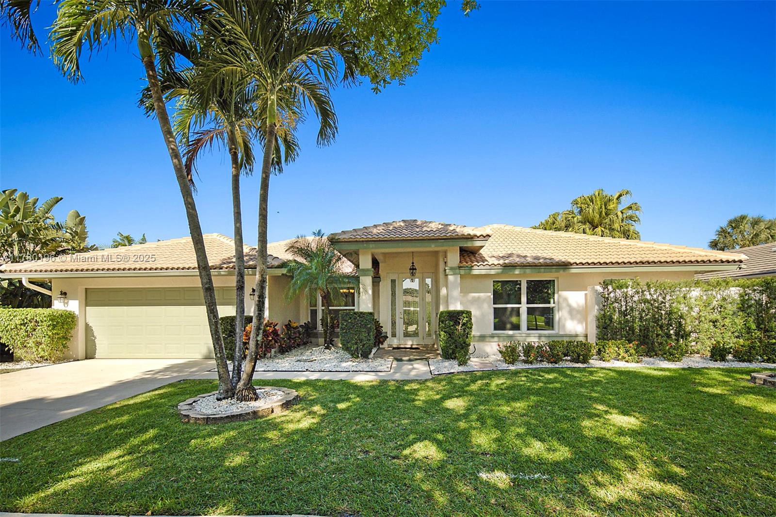 18295 Lake Bend Drive Jupiter, FL 33458 - Photo 1 of 64 a front view of a house with garden