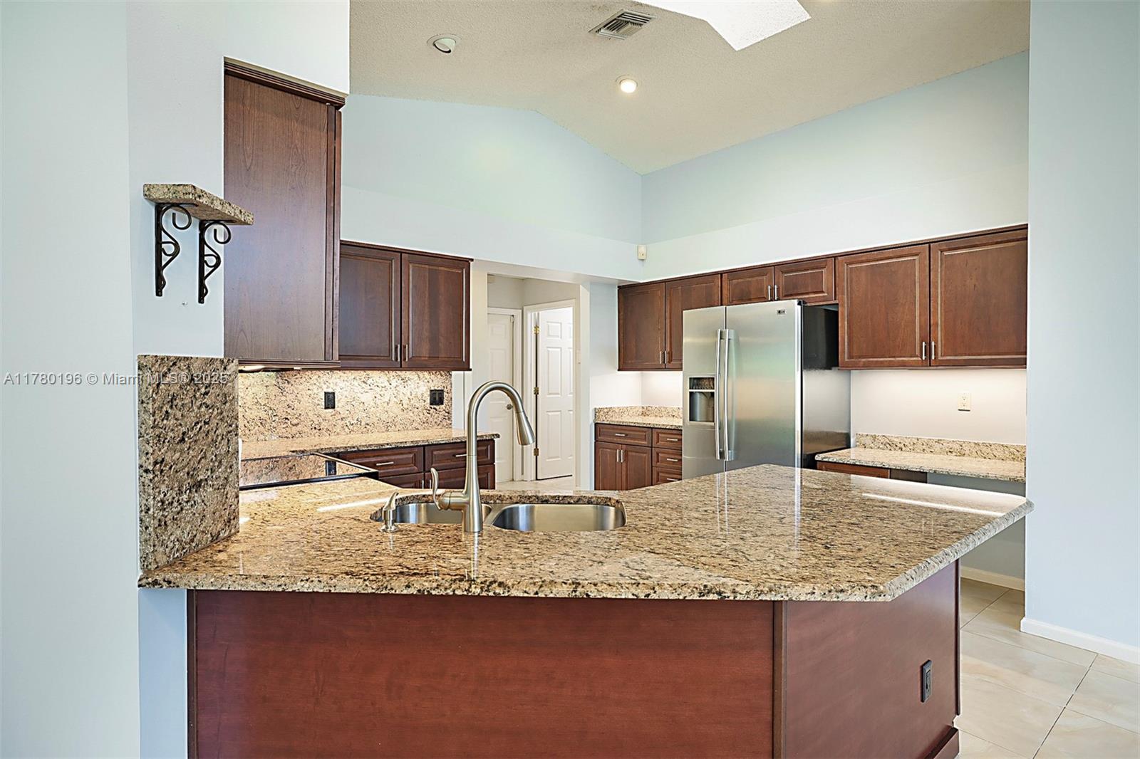 18295 Lake Bend Drive Jupiter, FL 33458 - Photo 17 of 64 a kitchen with granite countertop a sink a stove and refrigerator