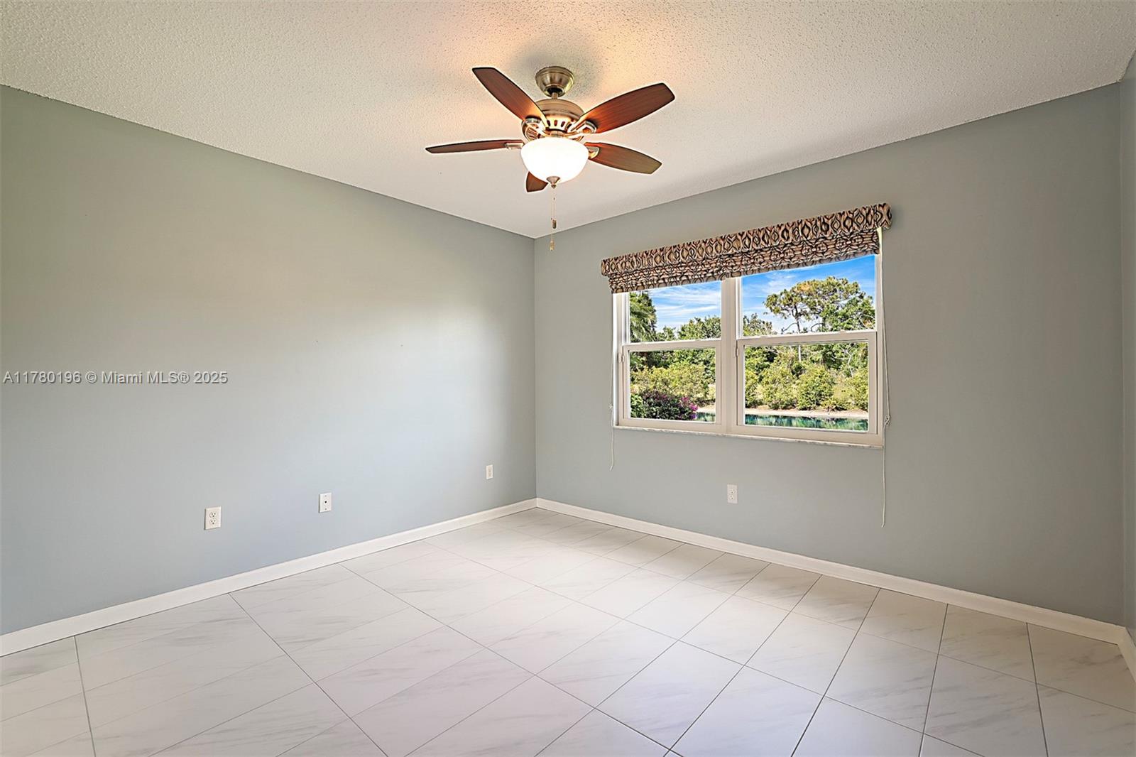 18295 Lake Bend Drive Jupiter, FL 33458 - Photo 30 of 64 an empty room with ceiling fan and window
