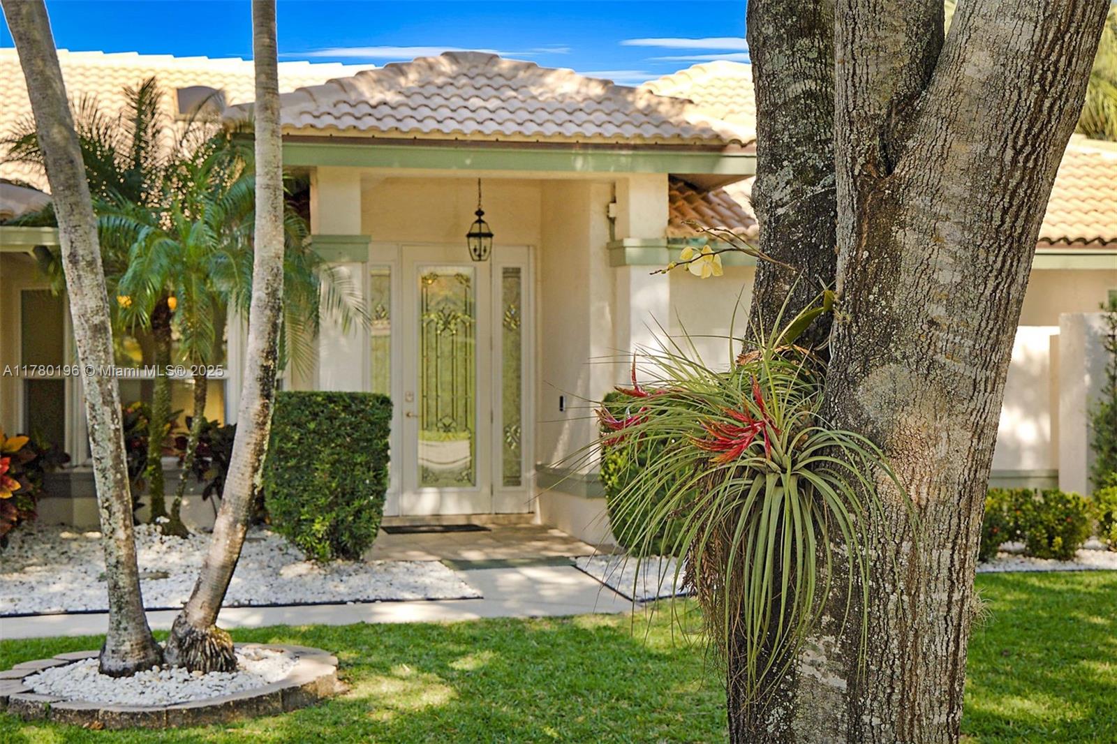 18295 Lake Bend Drive Jupiter, FL 33458 - Photo 3 of 64 a front view of a house with a yard