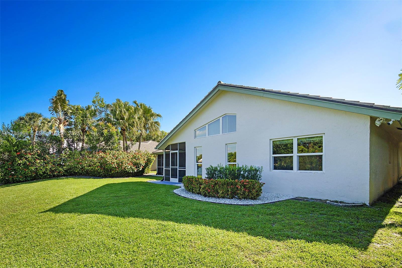 18295 Lake Bend Drive Jupiter, FL 33458 - Photo 42 of 64 a front view of house with yard and green space